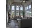 Bright living room featuring floor-to-ceiling windows, neutral tones, and comfortable seating at 413 Canterbury Way, Jonesboro, GA 30236