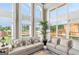 Bright living room featuring floor-to-ceiling windows, neutral tones, and comfortable seating at 413 Canterbury Way, Jonesboro, GA 30236
