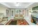 Cozy living room with a fireplace, comfortable seating, and a view to the exterior at 413 Canterbury Way, Jonesboro, GA 30236