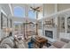 Bright living room features vaulted ceilings, indoor swing, fireplace, and access to the outdoor living space at 413 Canterbury Way, Jonesboro, GA 30236