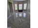 Large room with marble flooring and ample natural light from three windows at 413 Canterbury Way, Jonesboro, GA 30236