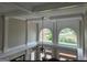 Vaulted ceiling with decorative columns and arched windows overlooking the lake at 413 Canterbury Way, Jonesboro, GA 30236