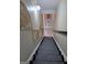 View of carpeted stairs leading downwards, with decorative wall art and lighting at 413 Canterbury Way, Jonesboro, GA 30236