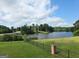 Scenic water view overlooking a tranquil lake surrounded by lush greenery and a beautiful, expansive lawn at 413 Canterbury Way, Jonesboro, GA 30236