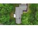 Aerial view of home featuring a well-maintained roof surrounded by lush green trees at 190 Willow Lake Ln, Sharpsburg, GA 30277