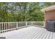 Large deck with white railings overlooking a beautiful wooded backyard at 190 Willow Lake Ln, Sharpsburg, GA 30277