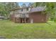 Home exterior featuring a brick facade, a deck, walk out basement and a well-maintained lawn at 190 Willow Lake Ln, Sharpsburg, GA 30277