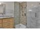 Contemporary bathroom features glass shower with unique tile and granite topped vanity at 190 Willow Lake Ln, Sharpsburg, GA 30277