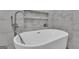 Close up of soaking tub with stylish chrome faucet and tiled alcove at 190 Willow Lake Ln, Sharpsburg, GA 30277