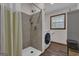 Charming bathroom featuring a tiled walk-in shower, a washing machine, and a small window for natural light at 190 Willow Lake Ln, Sharpsburg, GA 30277
