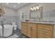 Bright bathroom with modern vanity, soaking tub, tiled accent wall and granite countertops at 190 Willow Lake Ln, Sharpsburg, GA 30277