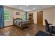 Bright bedroom with hardwood floors, natural light from two windows, and a matching wooden dresser at 190 Willow Lake Ln, Sharpsburg, GA 30277