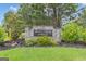 Stone sign for Shoal Creek Forest community surrounded by trees and landscaping at 190 Willow Lake Ln, Sharpsburg, GA 30277