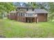 Two-story home featuring a brick facade, second story deck, and a spacious, green backyard at 190 Willow Lake Ln, Sharpsburg, GA 30277