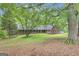 Attractive brick home with shutters, nestled among the trees, offering curb appeal and a serene setting at 190 Willow Lake Ln, Sharpsburg, GA 30277