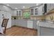 Bright kitchen with granite countertops, gray cabinets, stainless steel appliances, and hardwood floors at 190 Willow Lake Ln, Sharpsburg, GA 30277