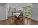 A bright kitchen space with custom cabinets, stainless appliances, and hardwood flooring with dining area at 190 Willow Lake Ln, Sharpsburg, GA 30277