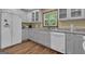 Inviting kitchen featuring a refrigerator with a water dispenser, ample counter space, and hardwood flooring at 190 Willow Lake Ln, Sharpsburg, GA 30277