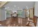 Open kitchen and dining area featuring hardwood floors, light grey cabinets, and natural light at 190 Willow Lake Ln, Sharpsburg, GA 30277