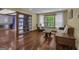 Comfortable living room with hardwood floors, bookshelves, and a view of the lush greenery outside the window at 190 Willow Lake Ln, Sharpsburg, GA 30277