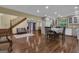 Open living room featuring hardwood floors, gray cabinets, and a staircase leading to the upper level at 190 Willow Lake Ln, Sharpsburg, GA 30277