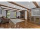 Spacious living room with wood beams, brick fireplace, and hardwood floors at 190 Willow Lake Ln, Sharpsburg, GA 30277
