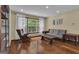 Inviting living room with a rocking chair, sofa, hardwood floors, and a large window offering a scenic view at 190 Willow Lake Ln, Sharpsburg, GA 30277