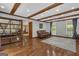 Large living room featuring wooden ceiling beams and natural light from many windows at 190 Willow Lake Ln, Sharpsburg, GA 30277
