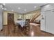 Spacious living area with hardwood floors, wooden staircase, and a dining table, perfect for Gathering gatherings at 190 Willow Lake Ln, Sharpsburg, GA 30277