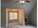Spacious attic area with window offering natural light, alongside carpeted and tiled flooring at 149 Titan Rd, Stockbridge, GA 30281