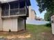 Backyard featuring a covered porch and a storage shed with a partial view of a neighboring house at 149 Titan Rd, Stockbridge, GA 30281