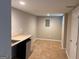 Finished basement with tile flooring, kitchenette area, and natural light from a small window at 149 Titan Rd, Stockbridge, GA 30281
