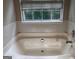 Bathroom featuring a tiled tub-shower combination and a large window for natural light at 149 Titan Rd, Stockbridge, GA 30281