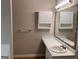 Bathroom with a vanity sink and mirror, complemented by white cabinets and a shower-tub combination at 149 Titan Rd, Stockbridge, GA 30281