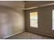 Bright bedroom with neutral walls and carpet, illuminated by natural light through a window at 149 Titan Rd, Stockbridge, GA 30281