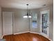 Cozy breakfast nook featuring hardwood floors, a view to the exterior, and a modern light fixture at 149 Titan Rd, Stockbridge, GA 30281
