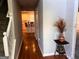 Inviting foyer with hardwood floors, staircase, decorative console table and view to the kitchen at 149 Titan Rd, Stockbridge, GA 30281