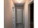 Hallway featuring neutral paint and carpet and doorways to bedrooms and a bathroom at 149 Titan Rd, Stockbridge, GA 30281