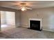 Spacious living room with a fireplace, carpet flooring and ceiling fan for added comfort at 149 Titan Rd, Stockbridge, GA 30281