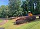 A colorful playground in a green community area with a swing set and a slide at 149 Titan Rd, Stockbridge, GA 30281
