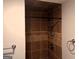 Tiled shower stall featuring a modern shower fixture and built-in shelving for toiletries at 149 Titan Rd, Stockbridge, GA 30281