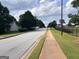 A street view within the neighborhood featuring sidewalks and well-maintained landscaping on a sunny day at 149 Titan Rd, Stockbridge, GA 30281