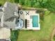 Aerial view of the backyard featuring a pool, patio area, and lush greenery surrounding the property at 2975 Hickory Hill Rd, Brooks, GA 30205