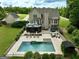 Stunning backyard showcasing a large in-ground pool, patio, and lush landscaping at 2975 Hickory Hill Rd, Brooks, GA 30205