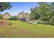 Spacious backyard with lush lawn, patio, pool, and mature trees at 2975 Hickory Hill Rd, Brooks, GA 30205