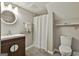Cozy bathroom features a modern vanity and a walk-in shower with white shower curtain at 2975 Hickory Hill Rd, Brooks, GA 30205