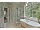 Bright bathroom boasts soaking tub, and spacious shower and great natural light at 2975 Hickory Hill Rd, Brooks, GA 30205