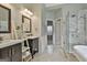 Luxurious bathroom with dual vanities, tiled flooring, and glass-enclosed shower at 2975 Hickory Hill Rd, Brooks, GA 30205