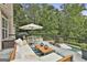 Inviting deck with comfortable seating, outdoor dining, and wooded views at 2975 Hickory Hill Rd, Brooks, GA 30205