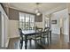 Dining room with wainscoting, a modern chandelier, hardwood floors, and neutral paint at 2975 Hickory Hill Rd, Brooks, GA 30205